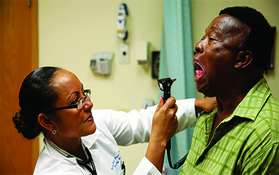 Doctor looking in patient's mouth